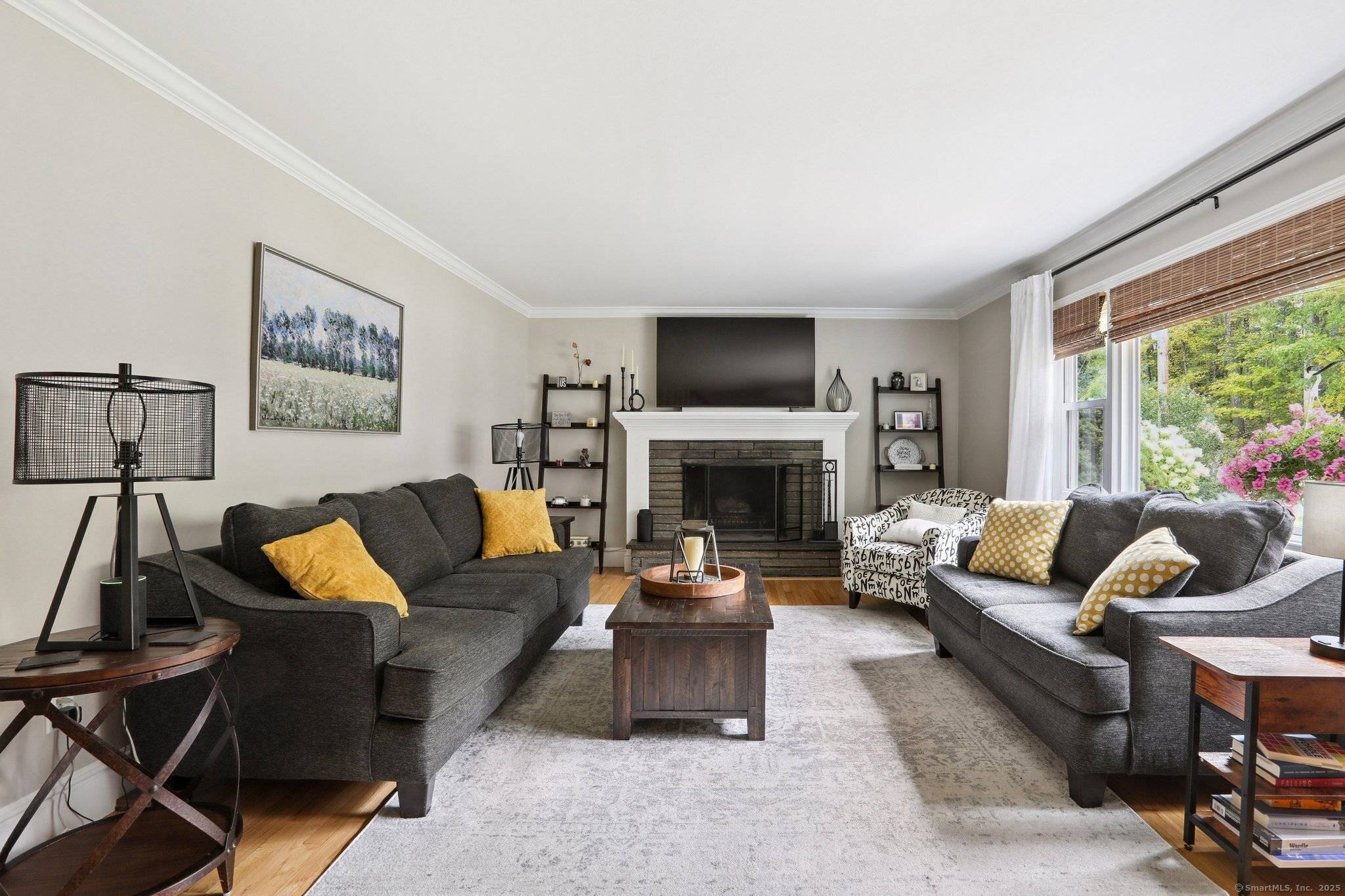 Updated Cape set on a picturesque, park like property with stonework, perennial gardens, and classic stone walls.
