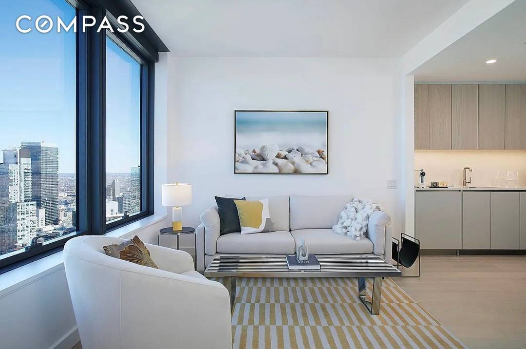 This high floor, northeast facing one bedroom apartment offers a generously sized living space, bathed in natural light that pours in through large curtain wall style windows.