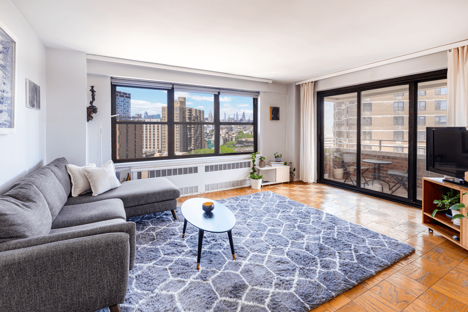 This rare, corner two bedroom, two bathroom home offers sweeping skyline views over the historic Lower East Side.