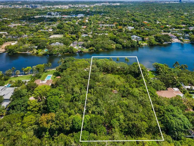 An extraordinary opportunity to build your dream home on a magnificent 2 acre lakefront lot in the prestigious gated community of Hammock Lakes.