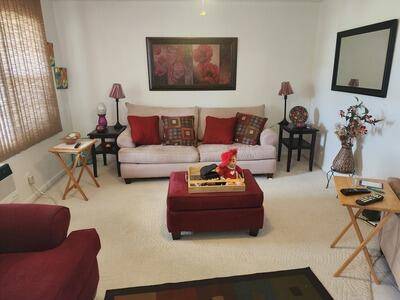 Enjoy peaceful lake views from this charming second floor apartment in an active, 55 gated community with 24 7 manned security at both entrances !