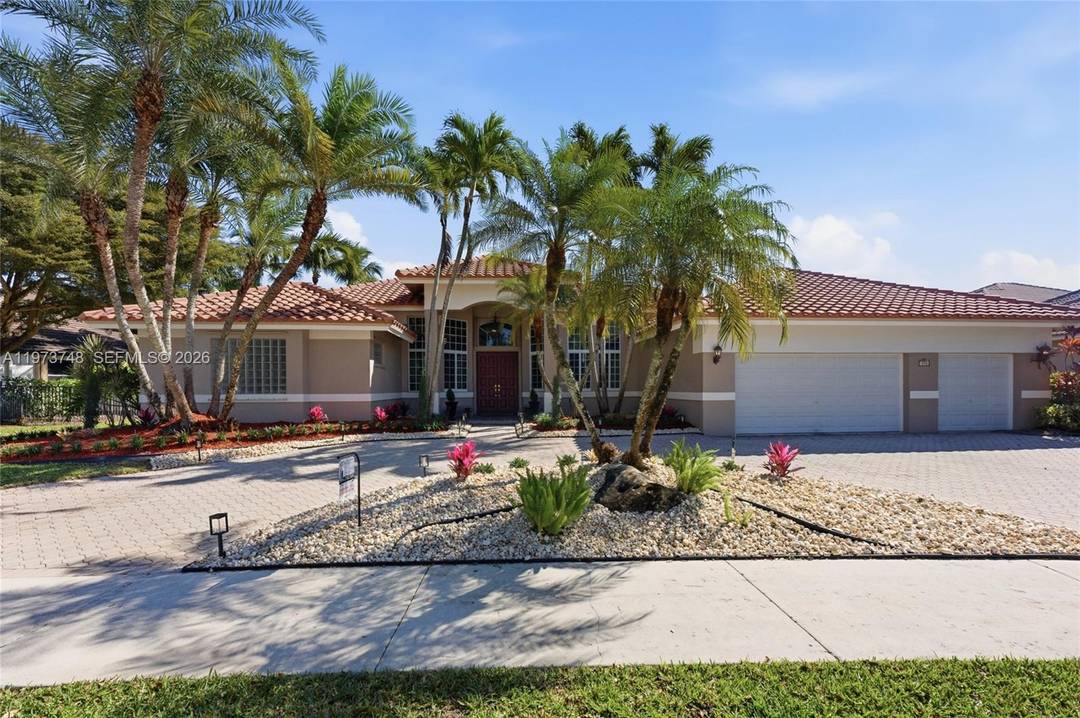 Welcome to this impeccably maintained one story custom home in the prestigious community of Pelican Landing in the heart of Weston.