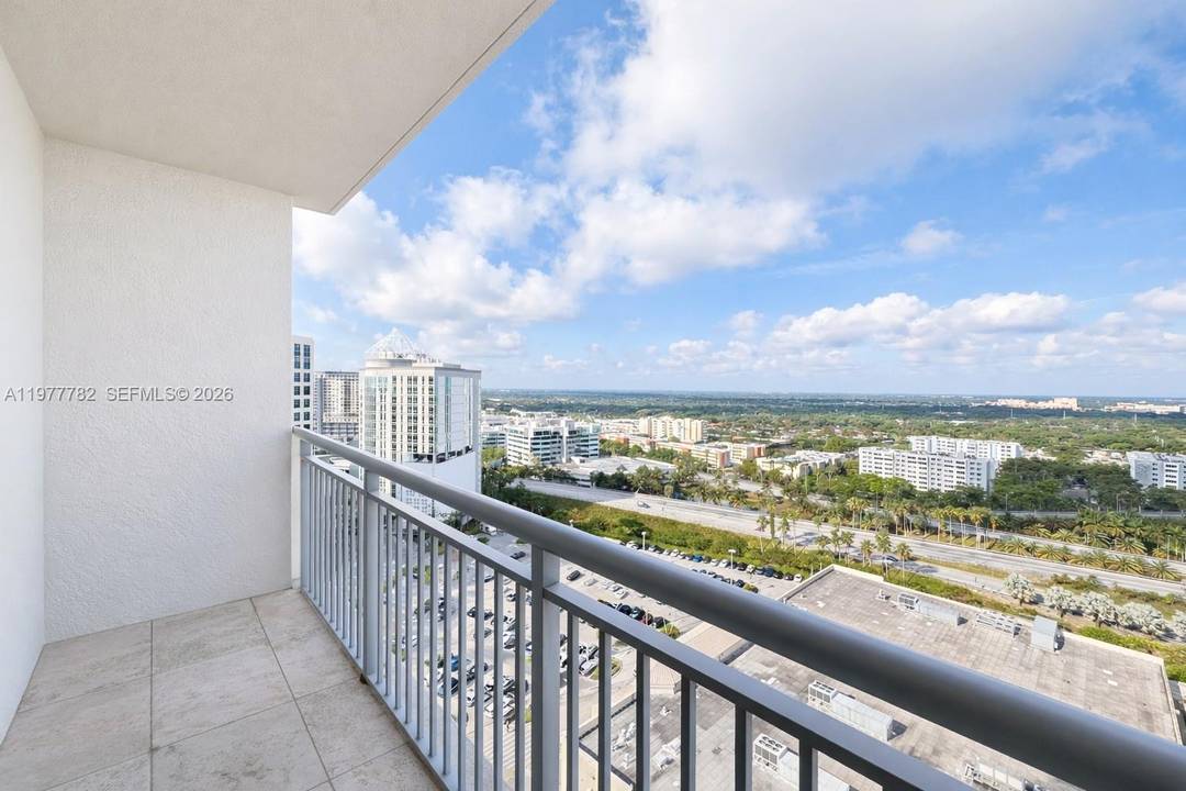 Spacious and well kept 2BR 2BA den residence at Metropolis at Dadeland featuring marble floors and bathrooms, a large galley style kitchen with granite countertops, leading into a full utility ...