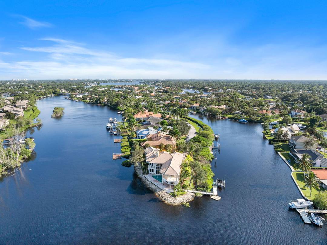 Claim your front row seat to the shoreline in this custom estate, perfectly positioned on a rare point lot at the tip of a private peninsula along the scenic Loxahatchee ...