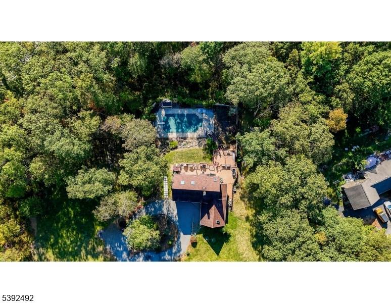 This stunning custom home sits on over 3 acres of gorgeous grounds, featuring a 20' x 40' inground pool, multi level Trex decks, and beautiful outdoor spaces perfect for entertaining.