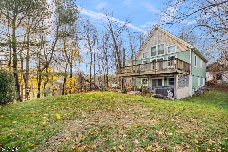 Step into this beautiful, custom timber frame Cape set on a private road and located within steps of Greenwood Lake, offering privacy, craftsmanship, and a true lake lifestyle setting.