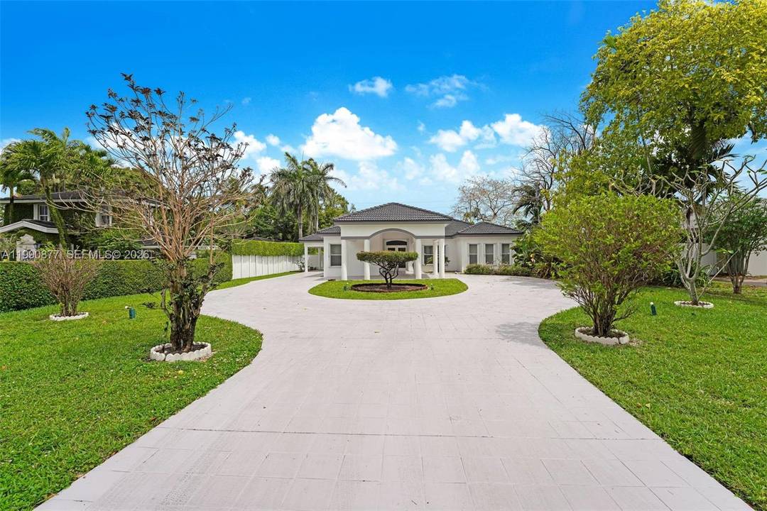Peacefully set along a tranquil canal in Miami Springs, this light filled residence offers a spacious open layout with soaring ceilings and an effortless indoor outdoor feel.