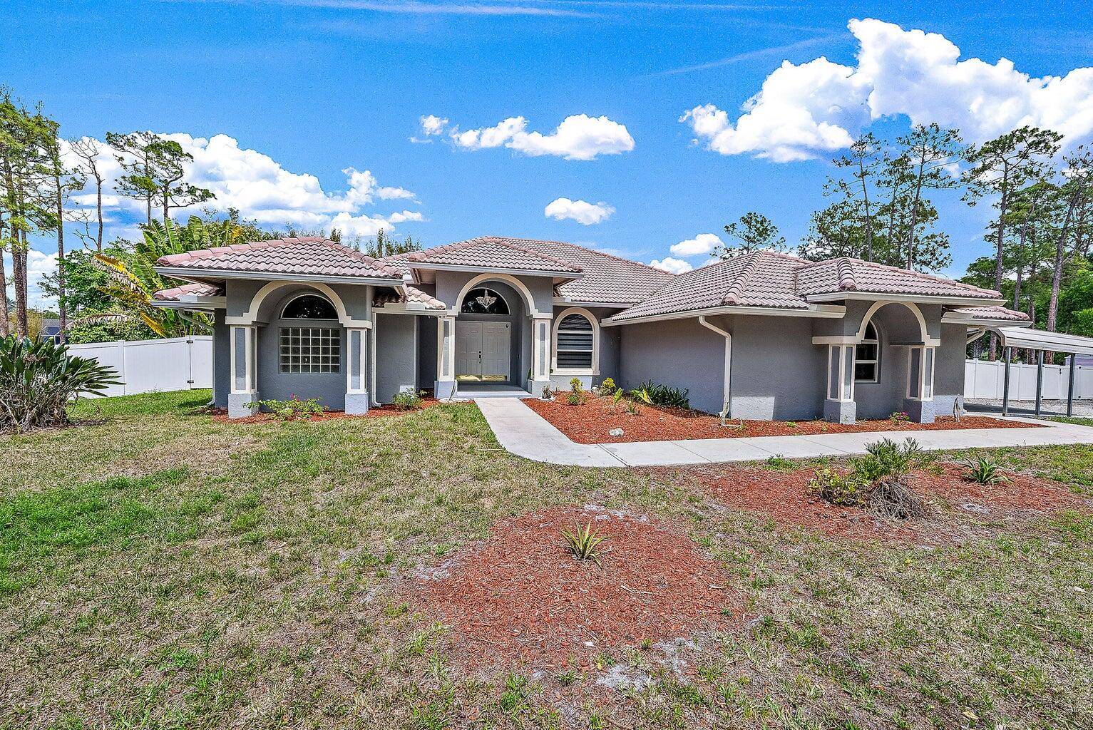 EXTREME PRIVACY AMAZING 3 BEDROOM 2 BATH 2 CAR GARAGE WITH TILE ROOF PLUS SCREENED POOL WITH EXTRA PRIVACY FENCE IN LOXAHATCHEE 1.