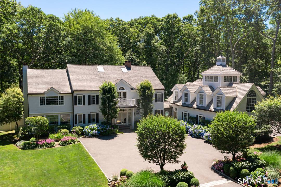 Set on 5 private acres at the end of a coveted cul de sac, this distinctive family compound is minutes to town and top rated schools.