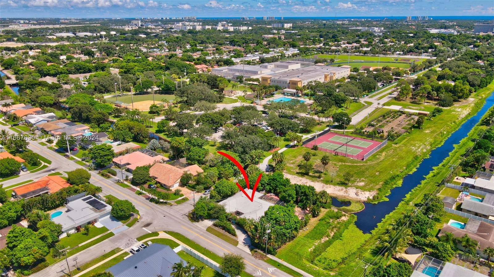 Discover a truly exceptional residence that promises both privacy and luxury, situated on a unique corner lot with serene canals on two sides and no neighbors.