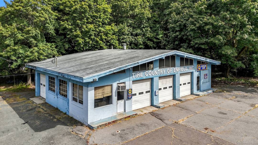 Five bay former auto repair facility with separate, adjacent wooded parcel, totaling approximately 4.