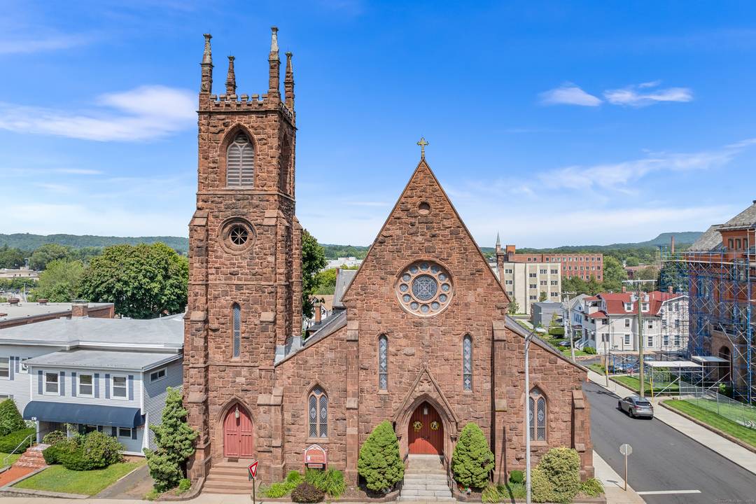 Built in 1870, this gable roofed Romanesque Revival, 22, 856 square foot, historic brownstone was designed by Henry Dudley of New York, known for Gothic Revival churches.
