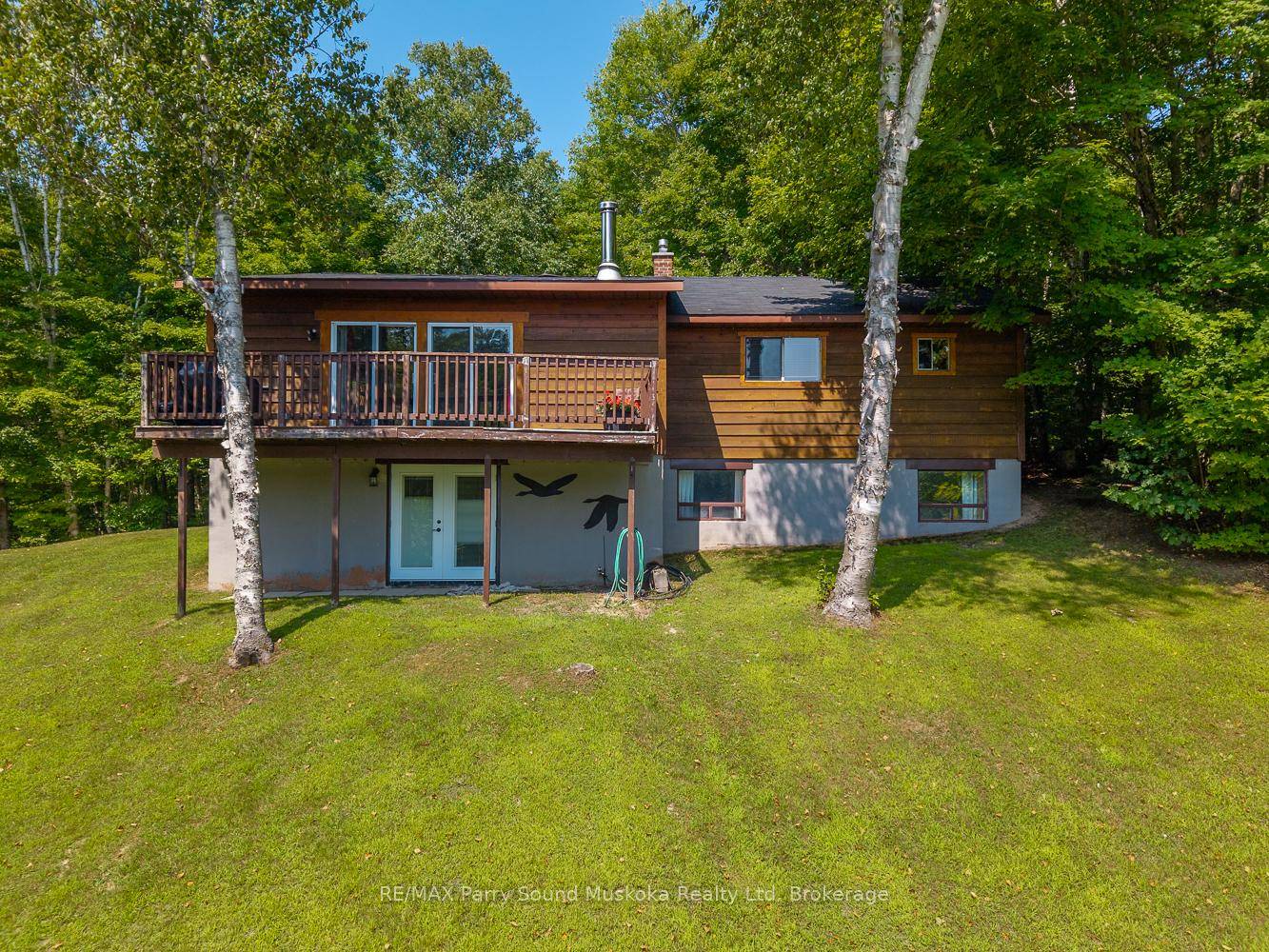 Over an acre of gently sloping property with 100 feet of sandy shoreline on Virtue Lake, perfect for swimming and family fun.