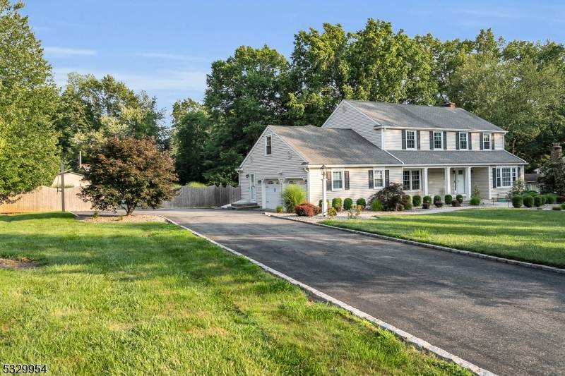 Meticulously updated 5 bedroom colonial situated on a private 1.