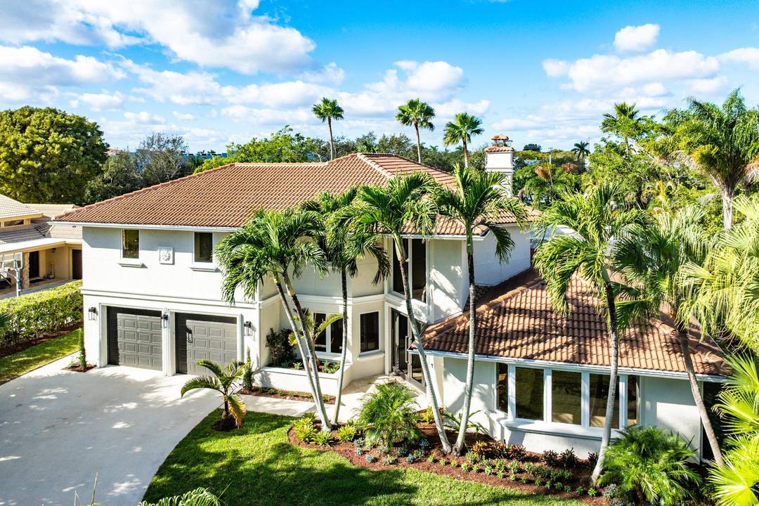 Welcome to this timeless Gulf Stream residence, perfectly situated on a large, private lot within Place Au Soleil.