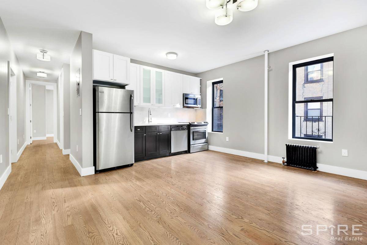 Upon entering the building's wrought iron gate, you're greeted by a beautifully landscaped courtyard connecting three building entrances as well as the common laundry room.
