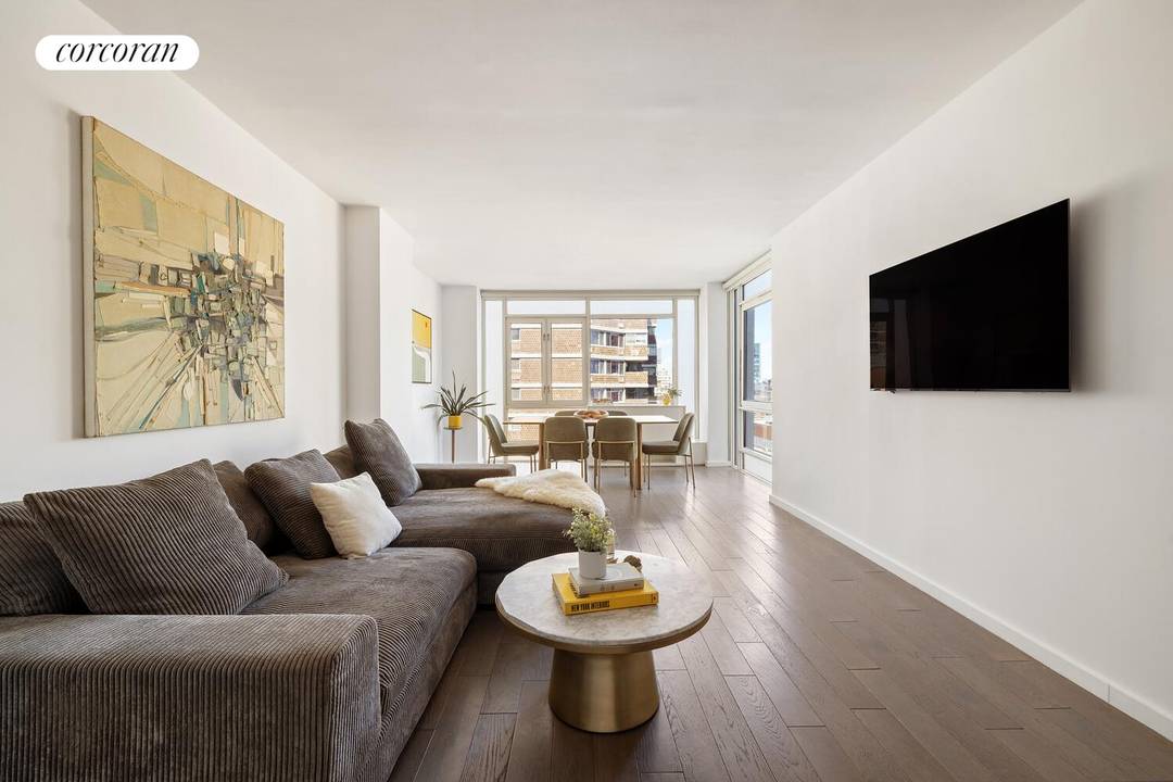 Enjoy exceptional natural light from oversized windows in this river facing corner two bedroom, two bathroom condominium home, where serene water views and vibrant city energy define the living experience.