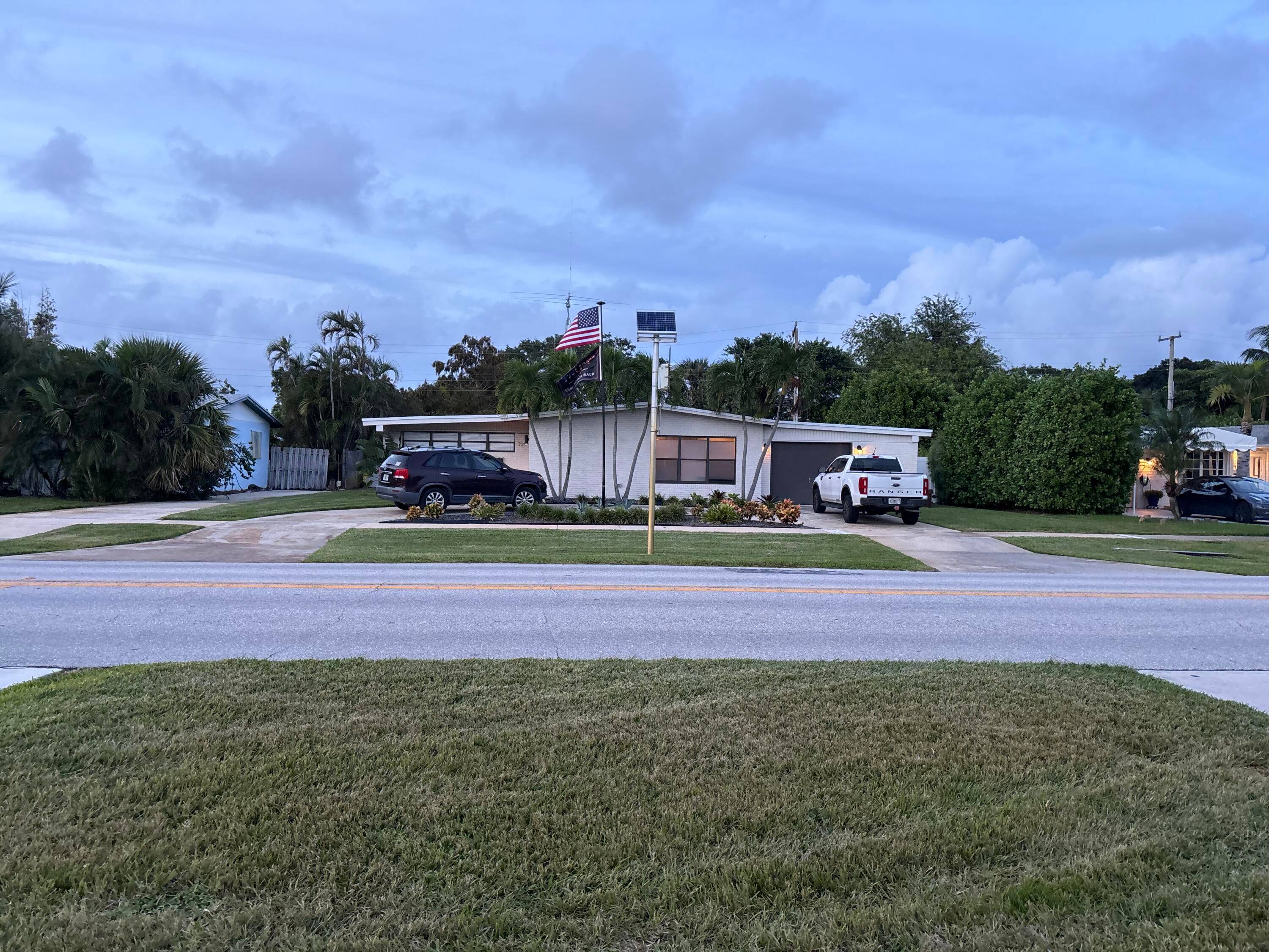 North Palm Beach 3 bedroom 2 bath, 2020 new roof, 2023 replaced A C circular driveway, w a large side yard for boat or RV.