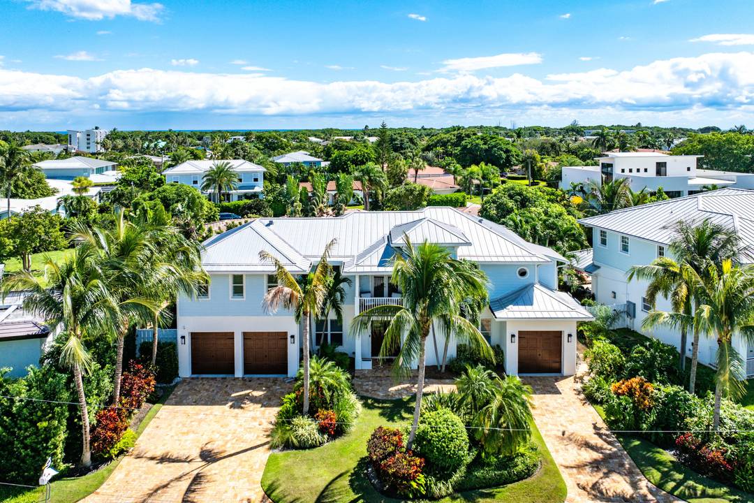 This Coastal Contemporary masterpiece is perfectly nestled between the Intracoastal Waterway and the crystal blue Atlantic Ocean.