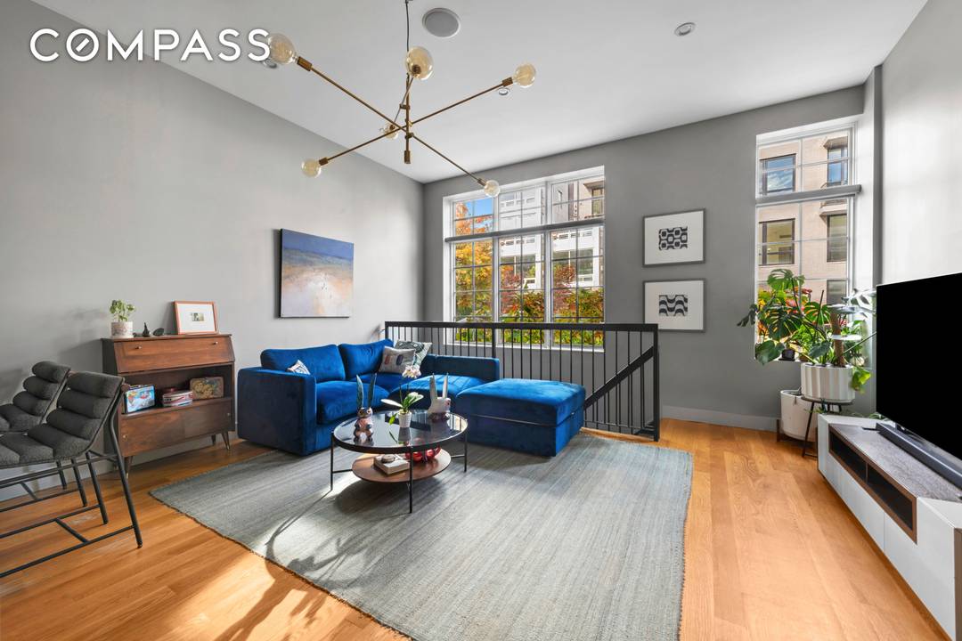 Experience the best of indoor outdoor living in Unit 1A, a dramatic duplex offering approximately 918 sq.