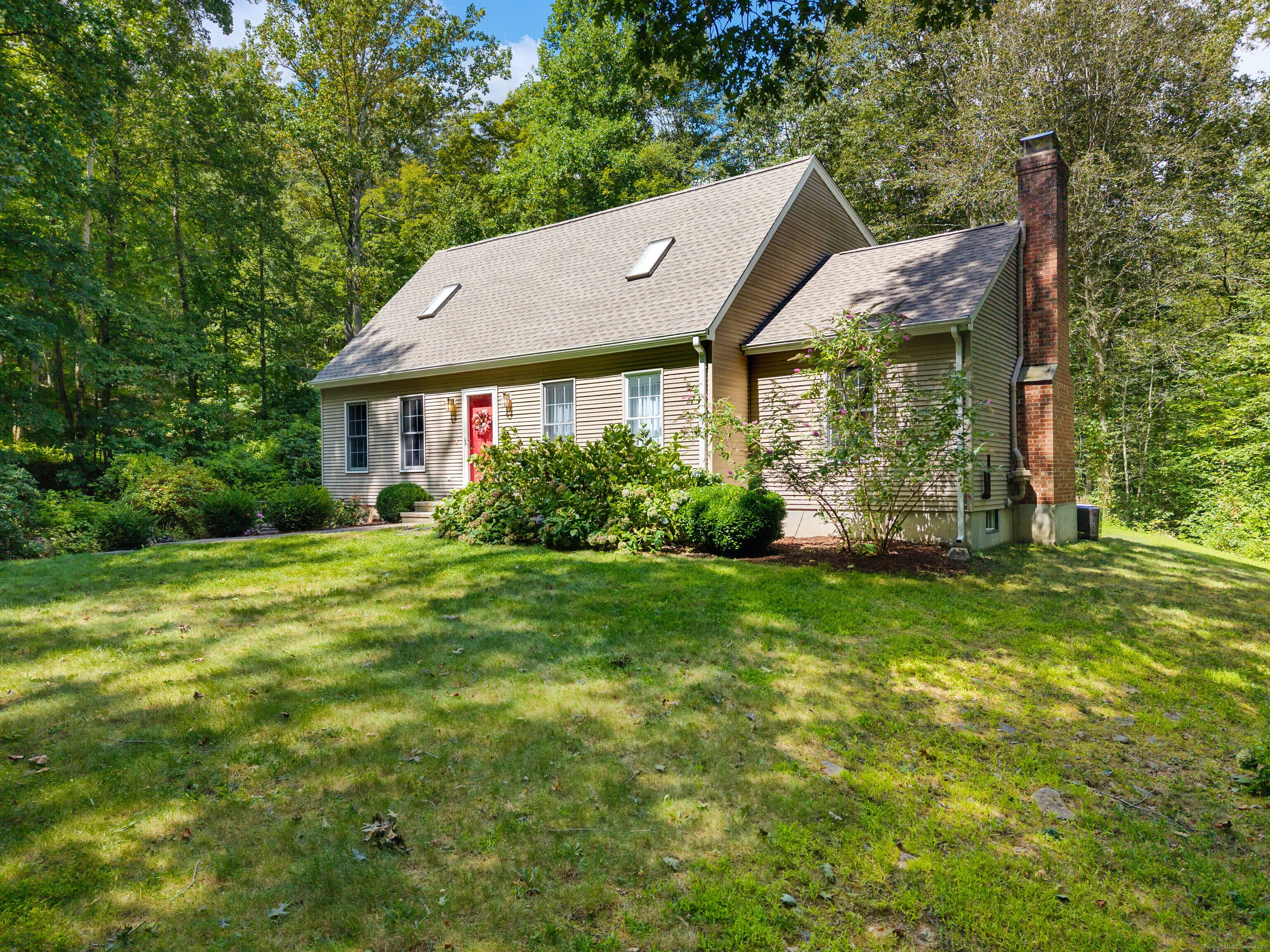 Welcome to 124 Kelsey Hill Road a beautifully updated Cape Cod set on nearly two private acres.