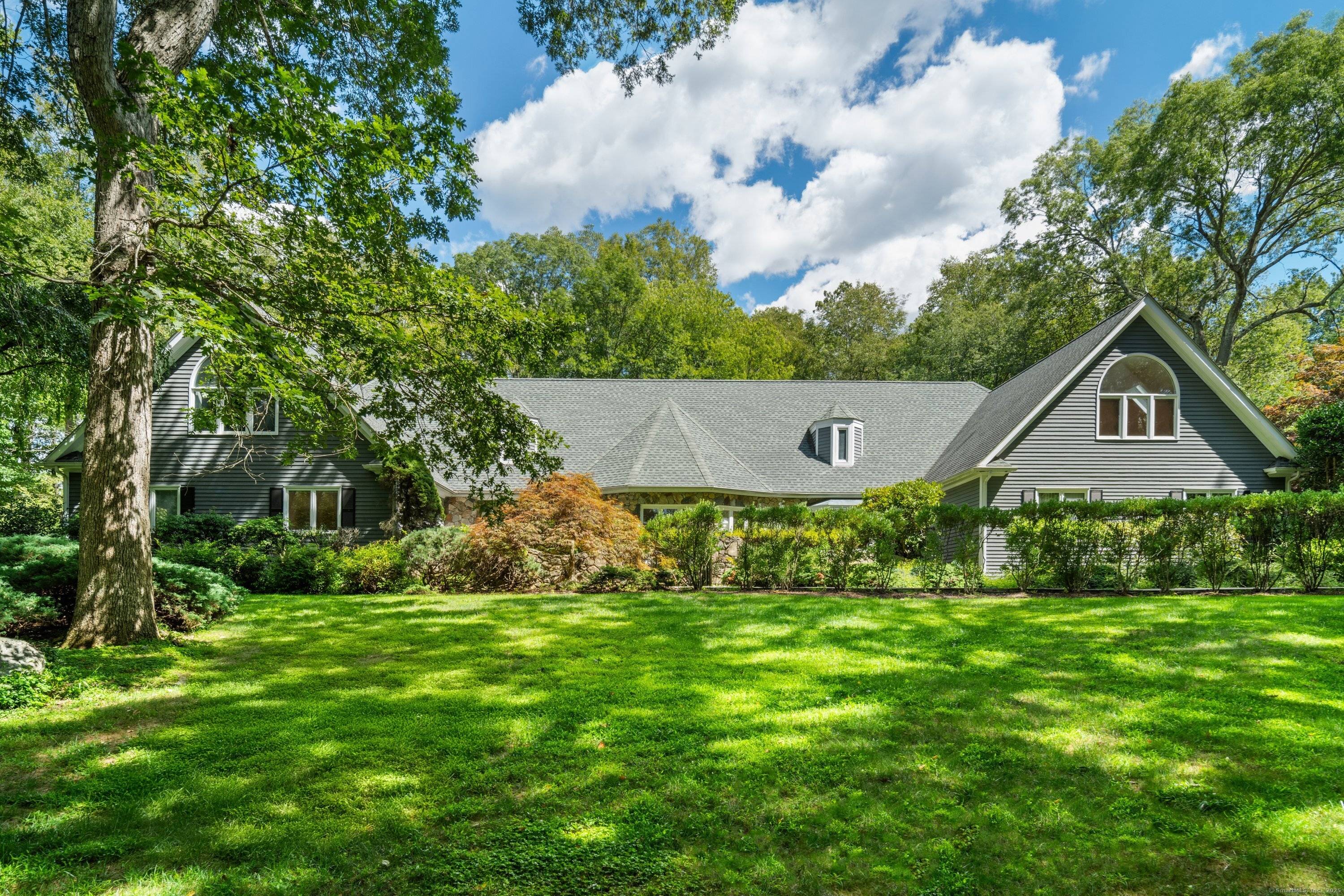 Set on over two private acres in the gated community of The Ridge, this stunning estate combines modern comfort with timeless design.