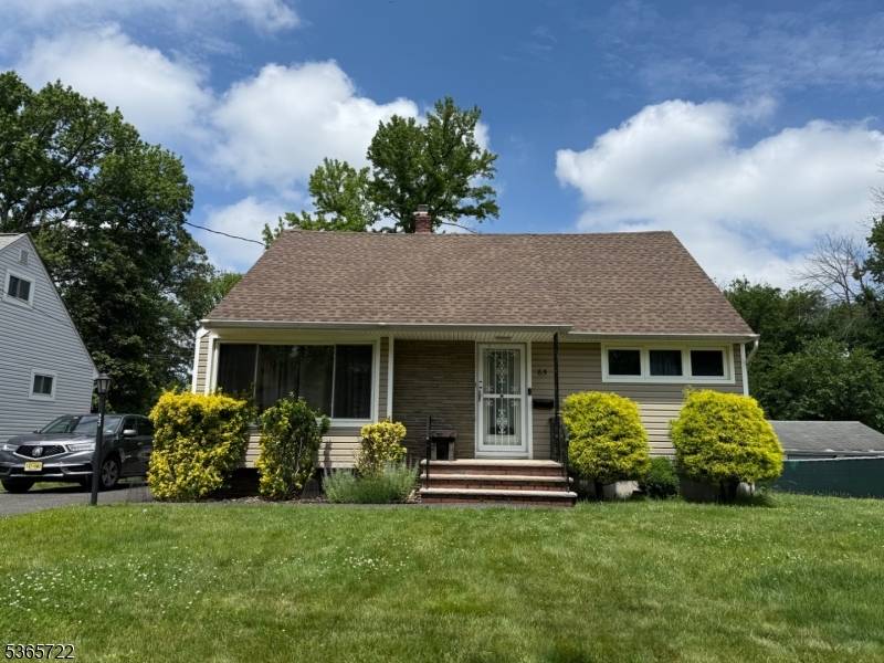 This charming cape code boasts four spacious bedrooms and two full bathrooms, perfect for entertainment.