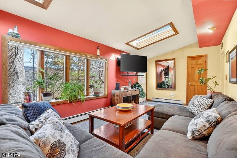 Set on over half an acre in scenic West Milford, this inviting 4 bedroom, 2.