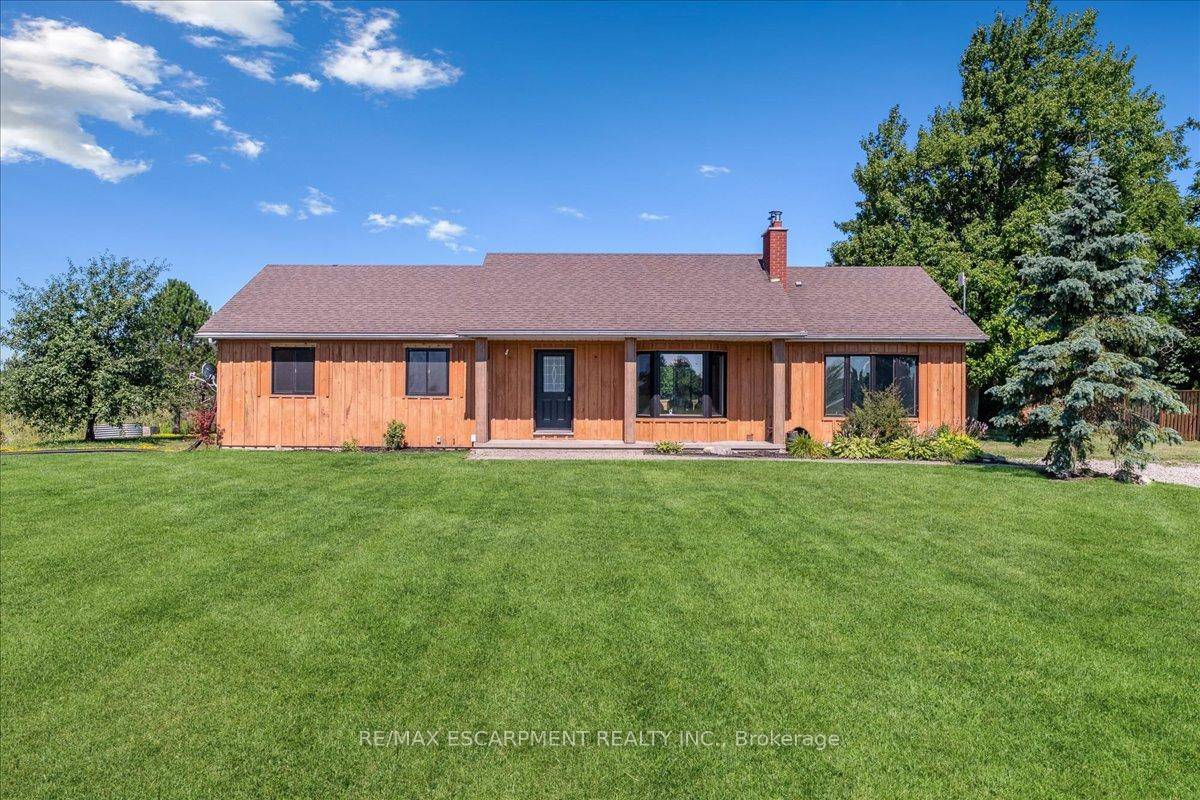 Set on just over an acre and backing onto tranquil farmland, this beautifully updated 4 1 bedroom, 4 bath bungalow offers the perfect blend of privacy, space, and convenience.