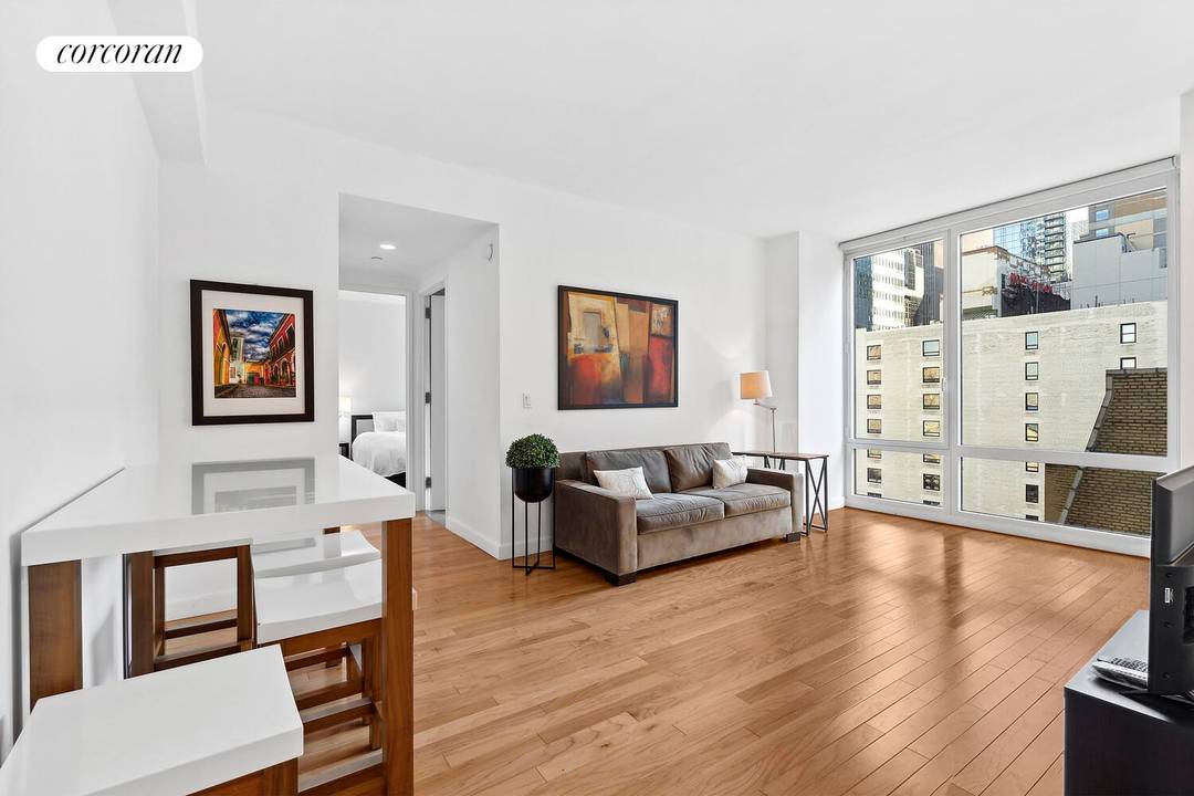 Wake up to soft eastern light pouring through floor to ceiling windows, high above Midtown.