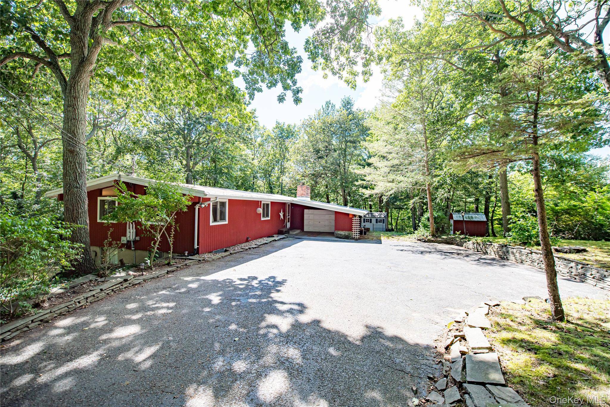 Three Bedroom Three Bath Mid Century Modern Ranch with Vaulted Ceilings, Hardwood Floors, Lower Level walkout, Decks amp ; Privacy.