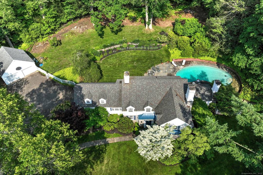 Nestled amidst lush, mature plantings, this stately 4 bedroom Colonial exudes timeless elegance and offers exceptional privacy.