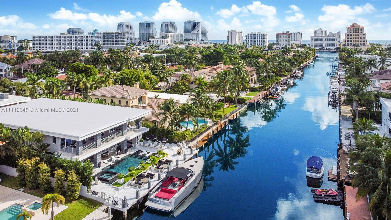 Exquisite modern estate on an oversized lot with 80 feet of deep water frontage.