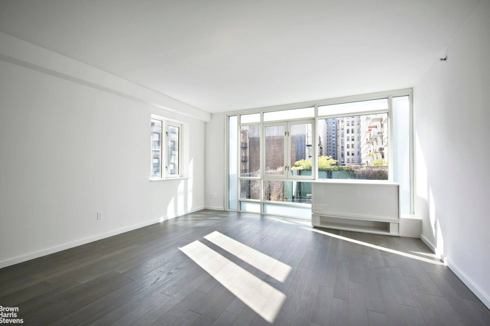 Floor to ceiling windows frame bright city views in this spacious one bedroom, one bathroom home.