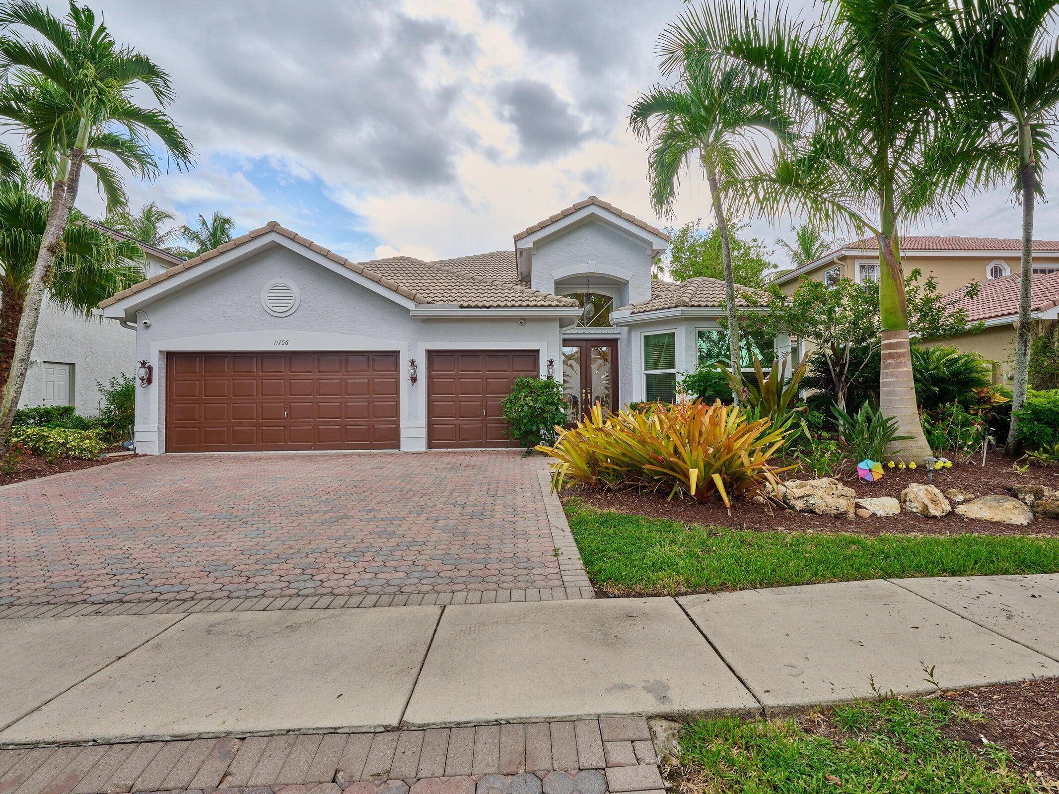 Live in style in this former model home featuring soaring ceilings, Saturnia marble floors, and a European style chef's kitchen with custom cabinetry, wall oven, and tumbled marble counters.