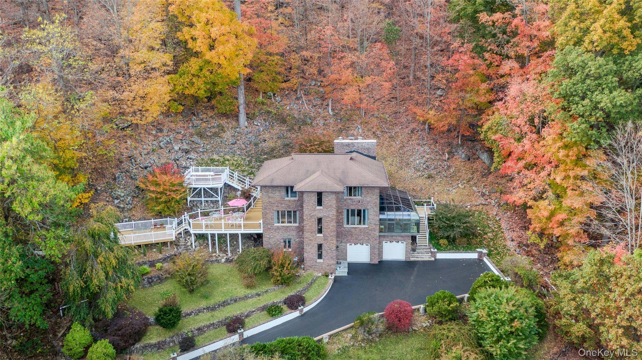 WHERE THE MOUNTAIN MEETS THE RIVER Carved directly into the mountainside and overlooking the Hudson River, this custom architectural designed contemporary home feels like a private retreat suspended between nature ...