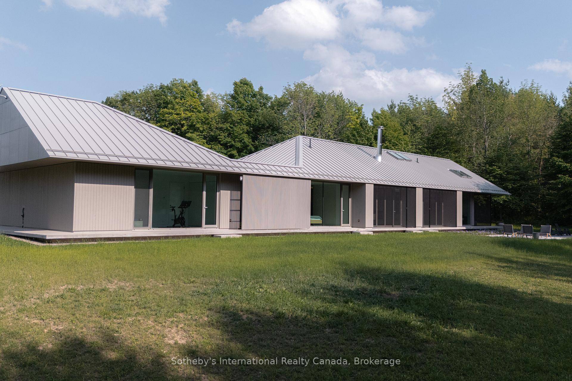 Welcome to Ridge House, a stunning blend of minimalist architecture and modern living, set on 25 acres of pristine land in the tranquil hamlet of Ravenna.