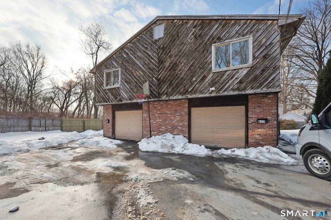 Contemporary style high ranch duplex tucked away for privacy but oh so convenient to shopping, highways, parks, and other amenities !