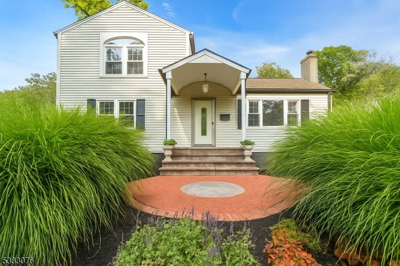 This Packanack Lake Custom home offers a versatile layout with a second floor primary suite featuring vaulted ceilings, walk in closet sitting room, and a full bath with a generous ...