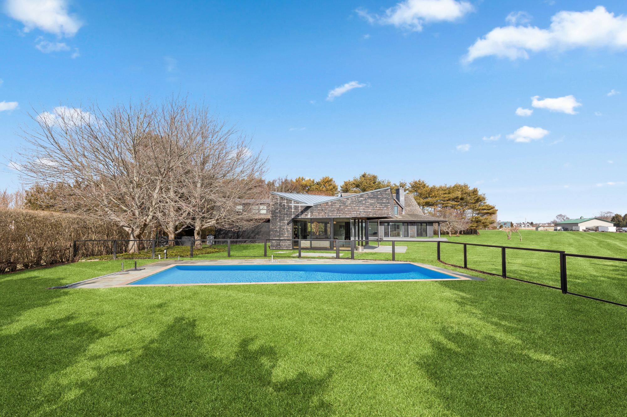 This private and architecturally acclaimed 4 bedroom, 3 bath home is situated south of the highway in Water Mill, overlooking serene farm views.
