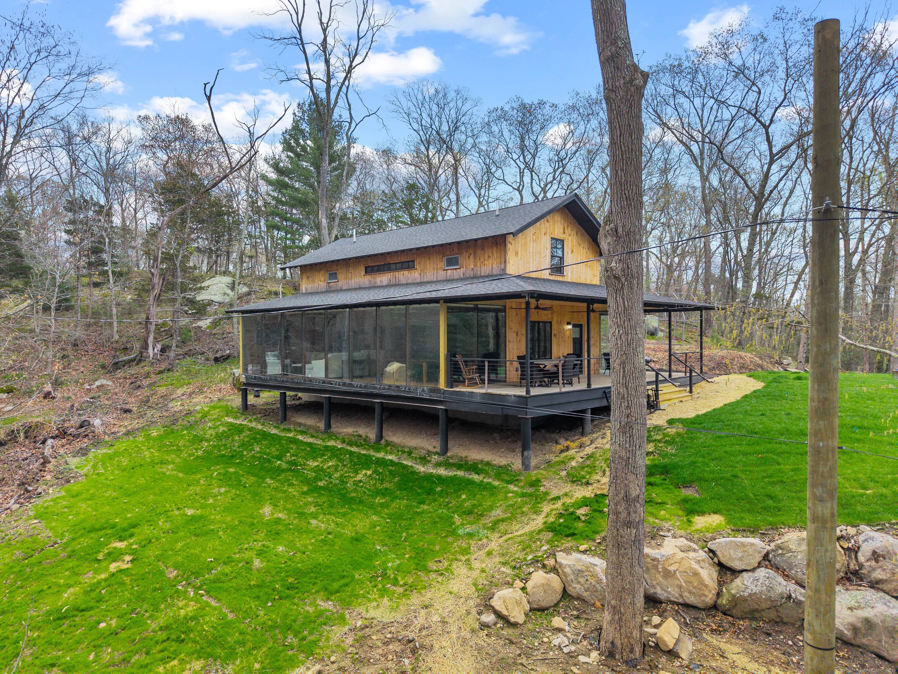 Set into the woods of Clinton, this 2, 400 sq ft modern farmhouse is designed for the discerning, uninhibited buyer.