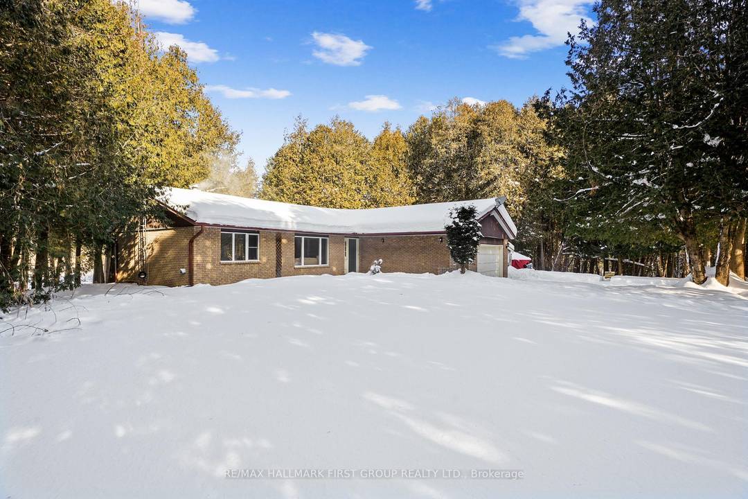 Classic charm meets country living in this timeless brick bungalow on 25 forested acres.