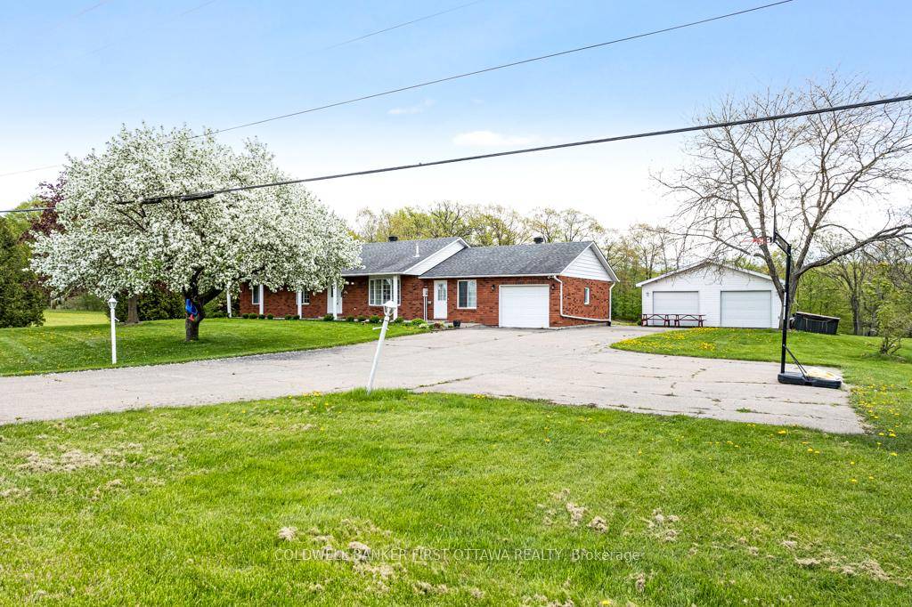 Attractive, curb appeal, brick bungalow with attached single garage plus, detached garage workshop.