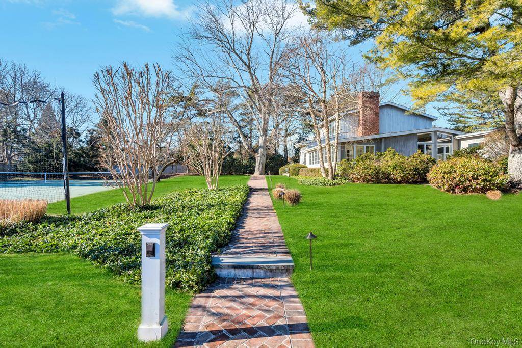 In the heart of Quogue Village, this bright, south facing home offers an exceptional lifestyle with effortless access to the village's charming historic downtown.