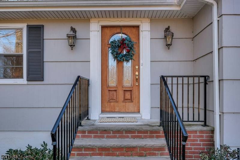 A charming walkway leads to the inviting front porch perfect for relaxing and taking in the changing seasons.