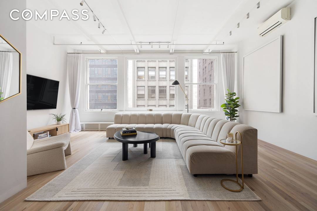A meticulously renovated loft in a storied 1909 Art Deco cooperative, Residence 6E blends architectural pedigree with modern sophistication just moments from Bryant Park.