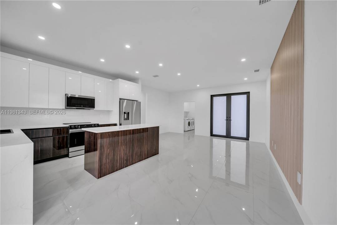 Stunning brand new 3 bedroom, 2 bathroom home featuring modern tile flooring throughout, upgraded lighting, and a sleek contemporary kitchen.