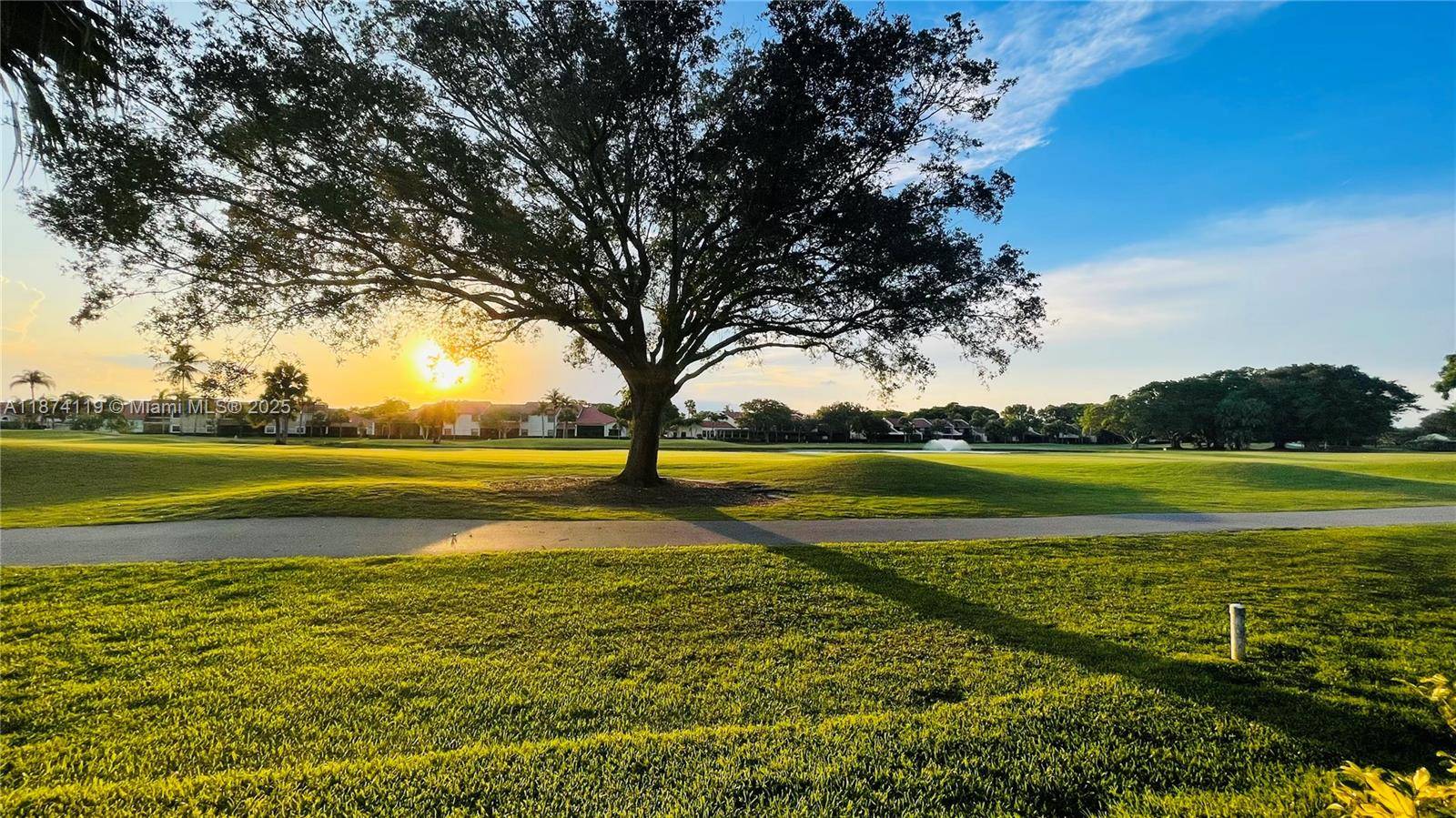 Welcome to your dream home, a stunning two story retreat with breathtaking golf and water views, nestled amidst beautiful gardens.