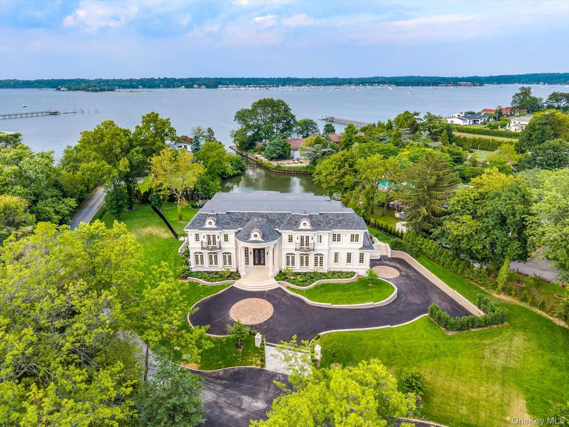Experience unparalleled luxury and craftsmanship in this spectacular new construction nestled on over an acre of pristine waterfront property in the heart of Kings Point.