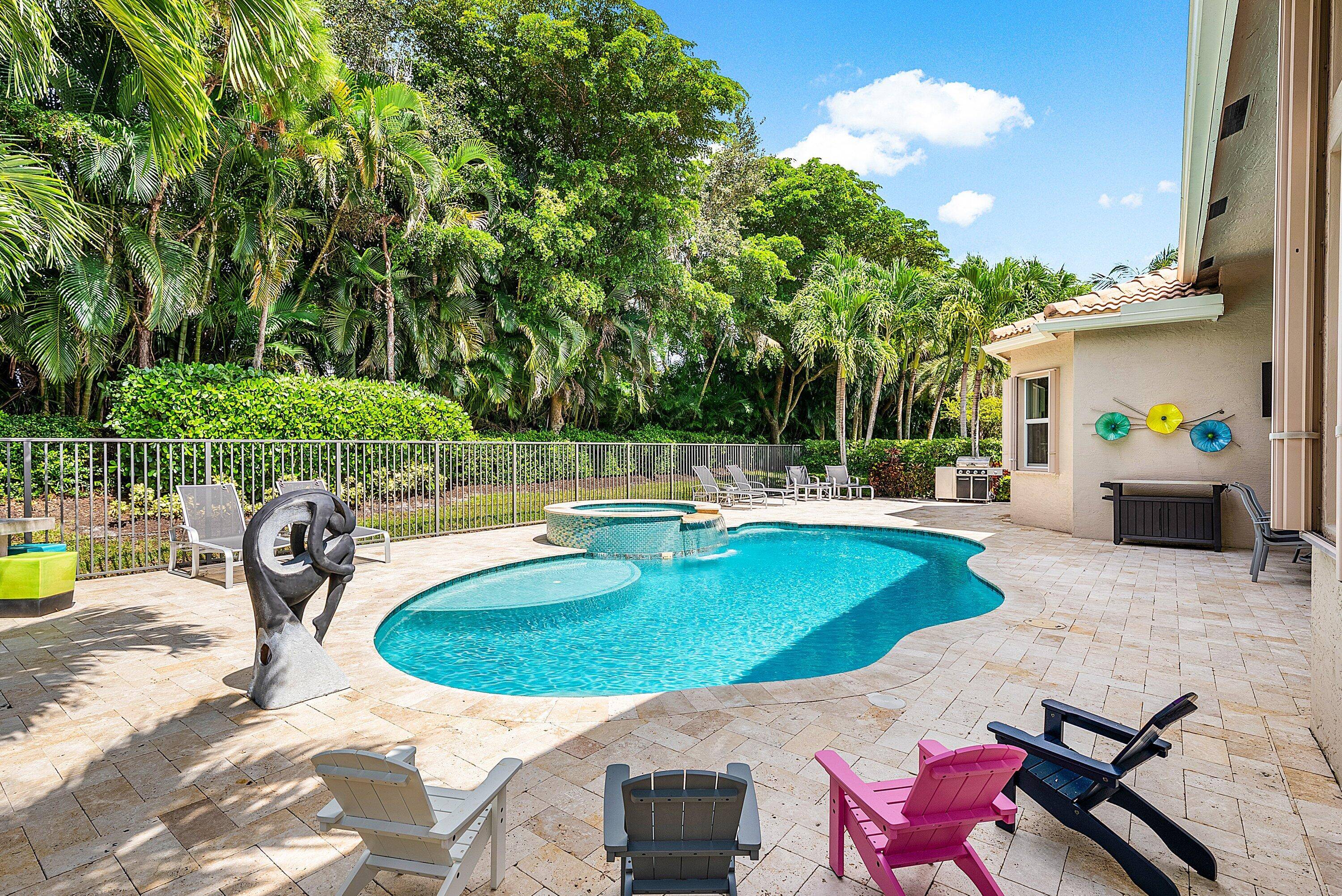 Decorator designed home featuring a stunning freeform heated pool with a spa and sundeck.